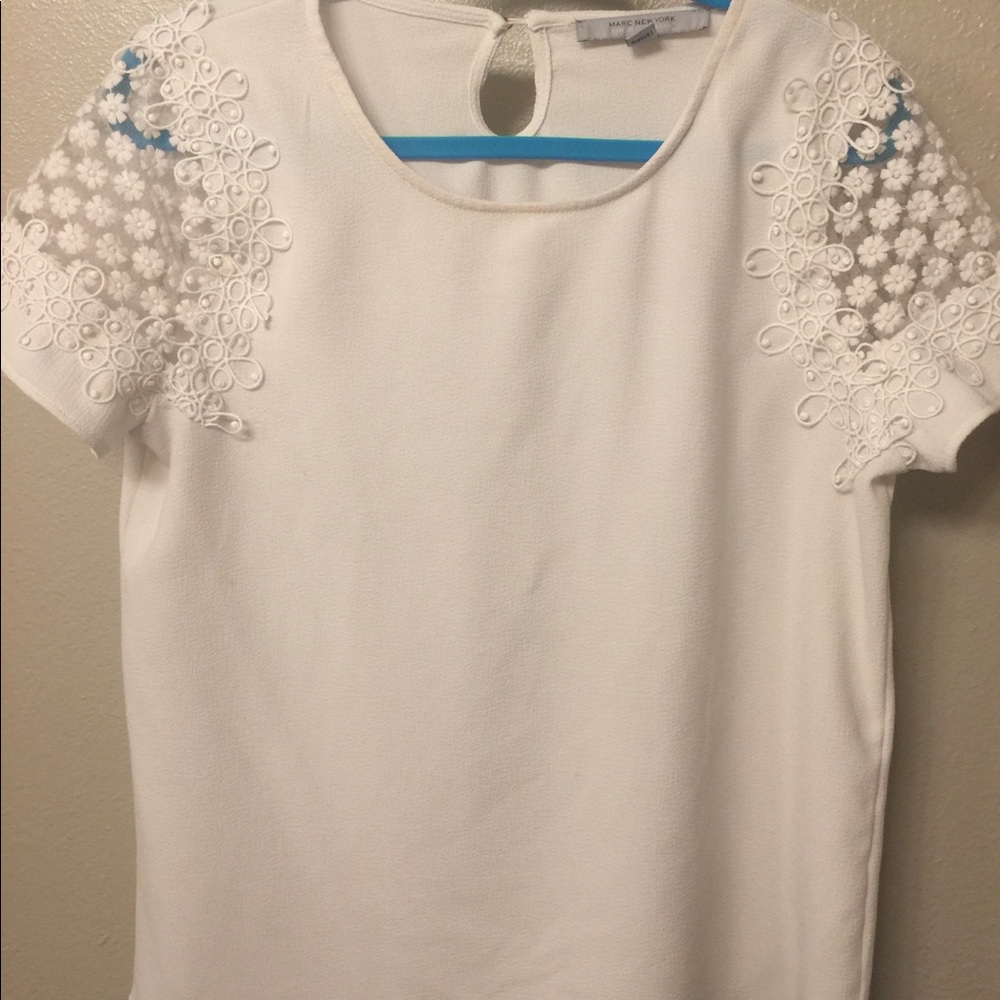 White blouse with floral shoulder detail